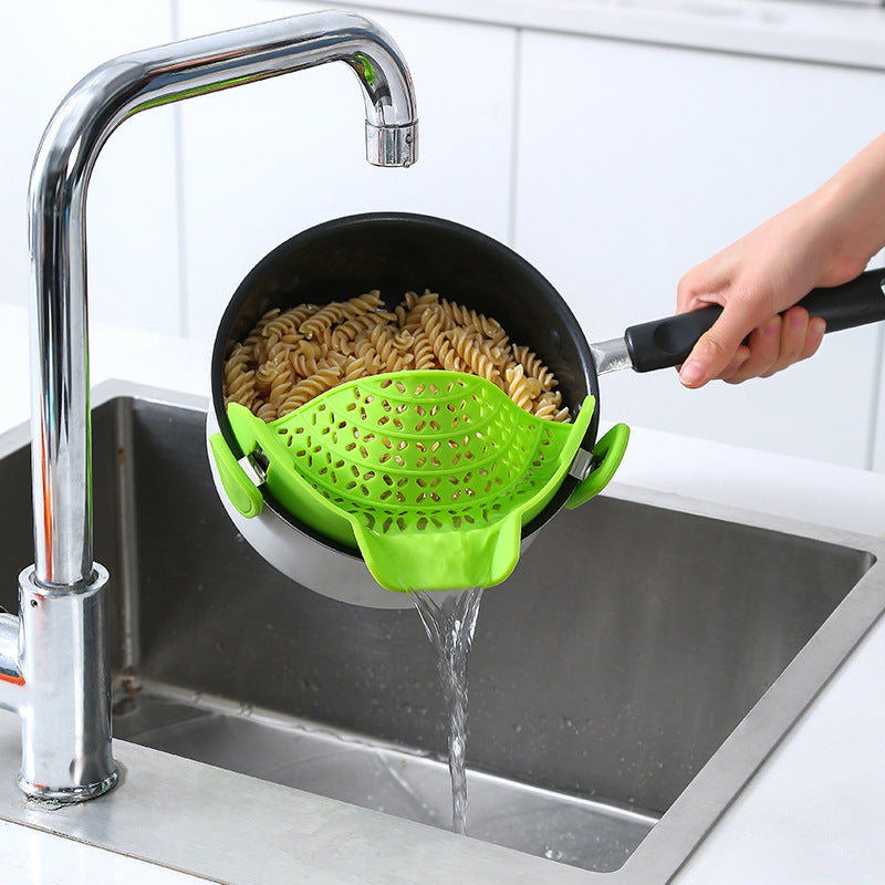 Silicone pot side drain stopper from R&G Boutique kitchen gadgets, designed to prevent spills and improve drainage.