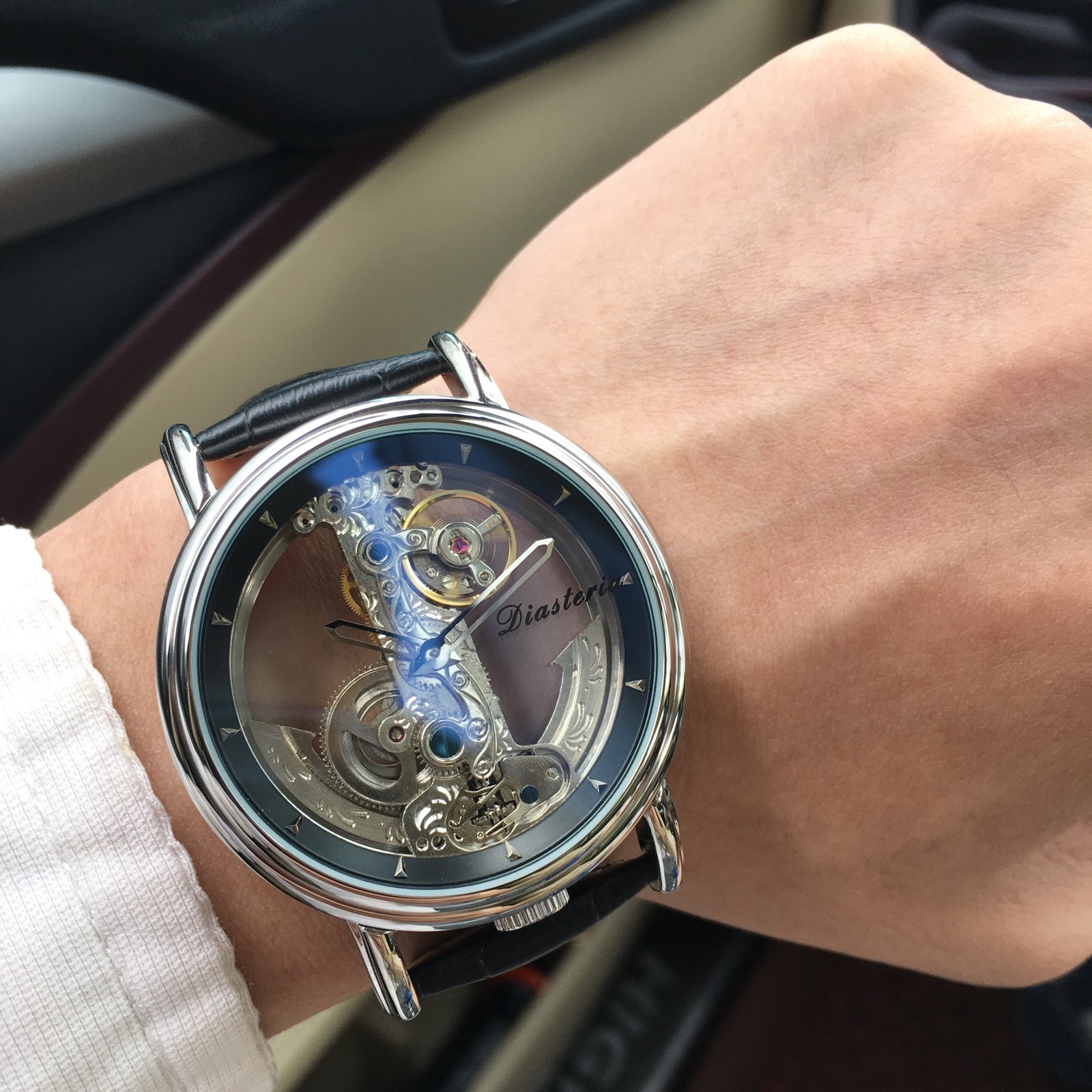 Double-sided hollow men's automatic mechanical watch by R&G Boutique showing the intricate dial and stainless steel strap.
