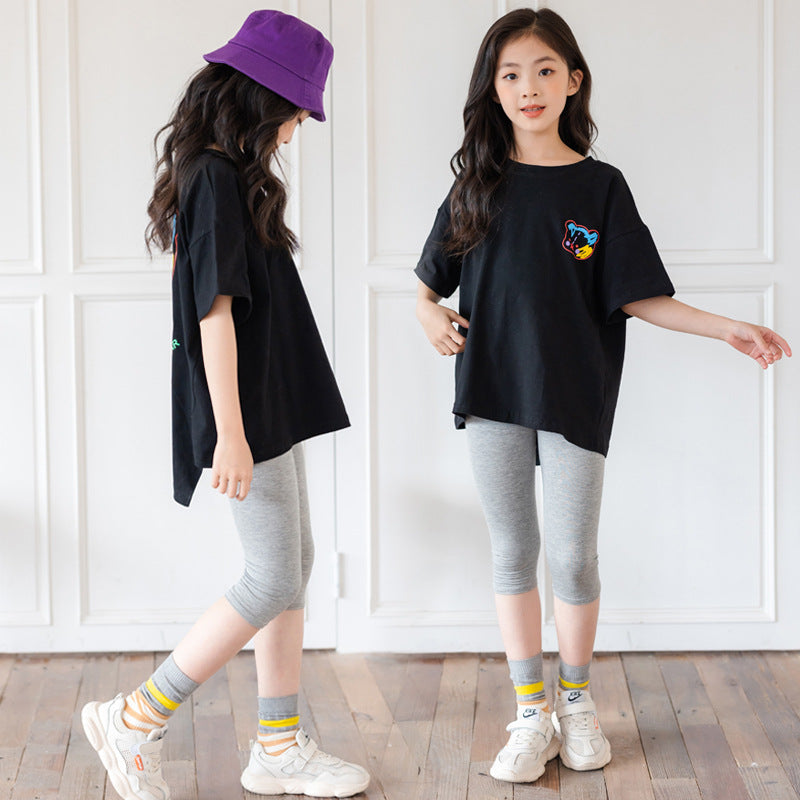 Colorful cartoon irregular short-sleeved top for big kids from R&G Boutique, featuring trendy, playful design and comfortable fit.
