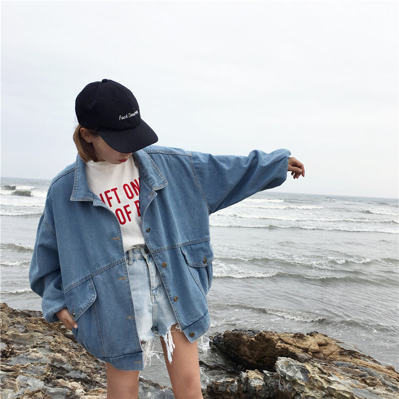R&G Boutique Esther denim jacket displayed on a hanger, showcasing classic blue jean style with button front and collar.