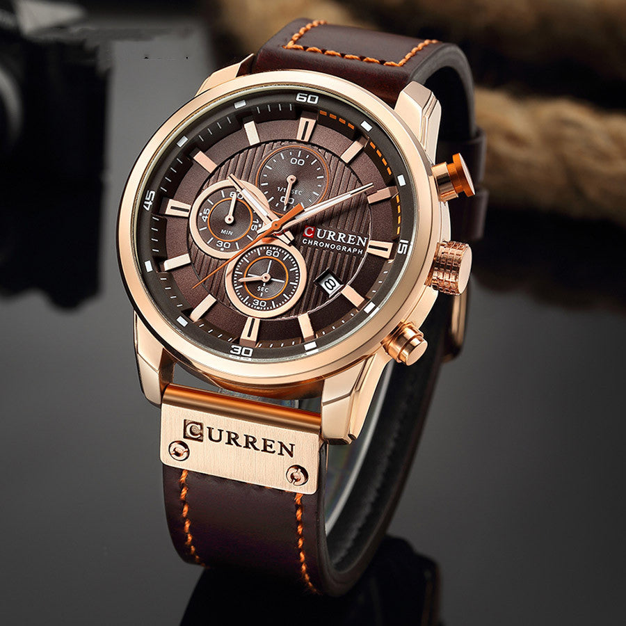 Men's quartz watch with black leather strap and silver dial from R&G Boutique, showing the watch face and strap details.