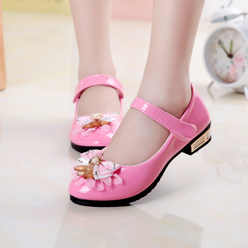 Cute girls' leather shoes with bowknot detail by R&G Boutique, featuring a stylish and comfortable design for young girls.