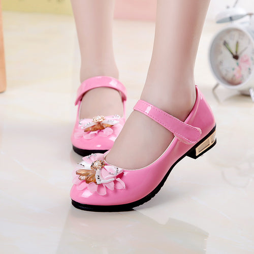 Cute girls' leather shoes with bowknot detail by R&G Boutique, featuring a stylish and comfortable design for young girls.