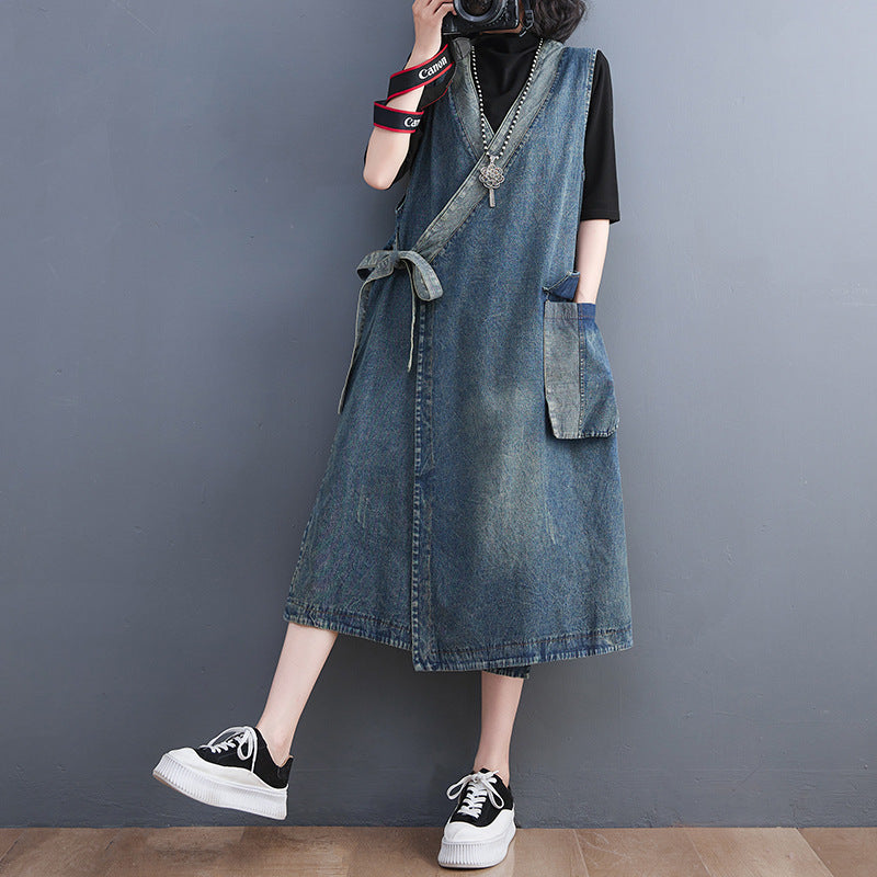 Vintage denim waistcoat camisole dress with diagonal placket and lace-up front, medium length, styled for women by R&G Boutique.